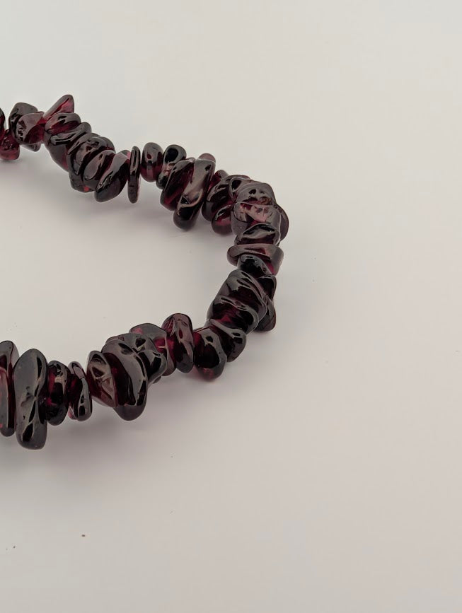 Detail of garnet chip bracelet highlighting dark claret tones