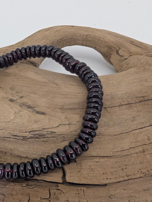 Close-up of garnet rondelles showing glossy luster and red undertone