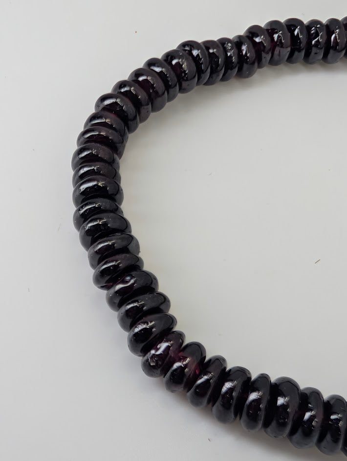 Detail of natural garnet beads with minimal inclusions and high polish
