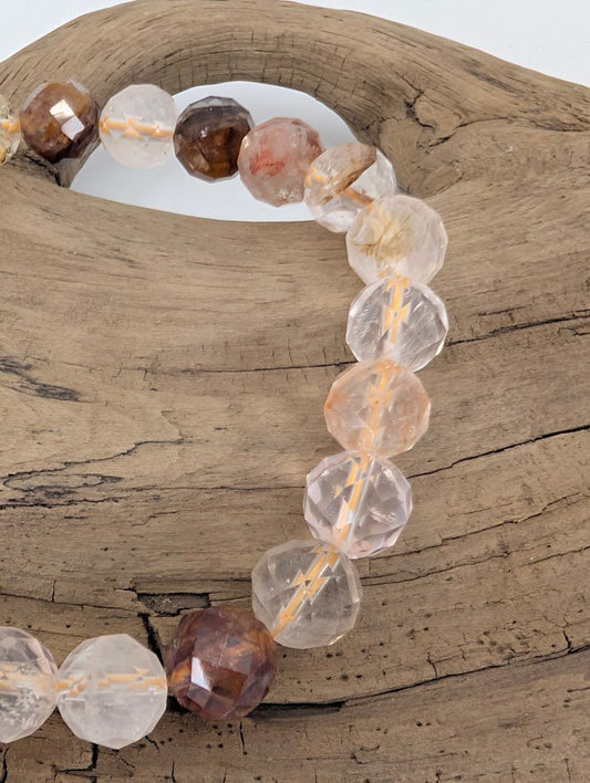 Close-up of Golden Healer Quartz faceted beads with golden veins