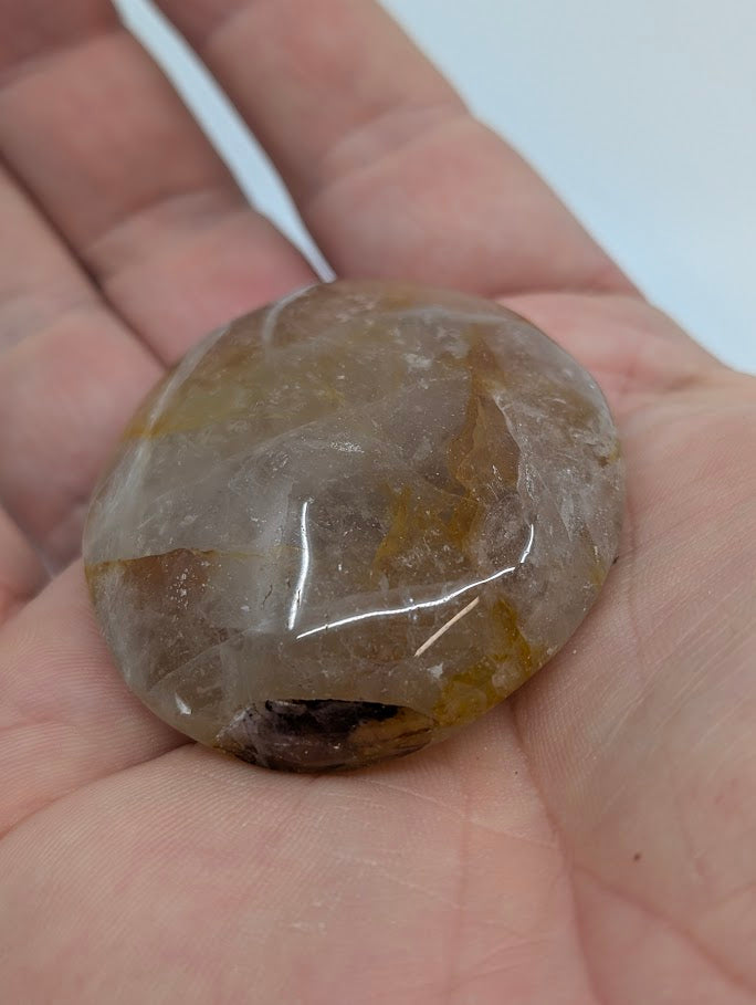 Golden Healer Quartz palm stone group display, polished and all-natural quartz with golden inclusions