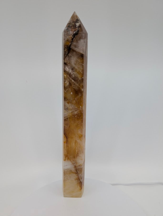 Tall Brazilian Golden Healer Quartz Tower under light
