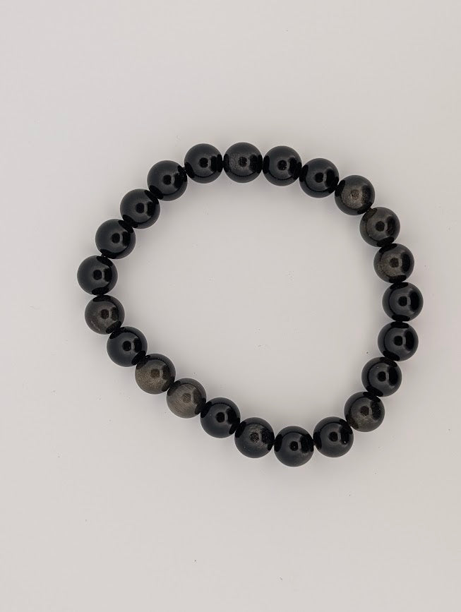Overhead view of 8mm Golden Obsidian bracelet on white background