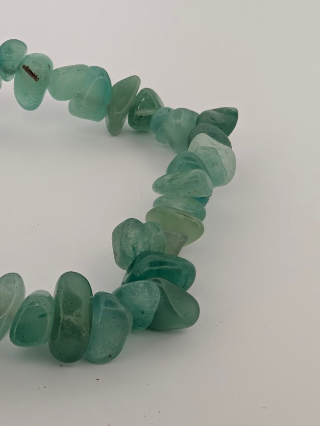 Macro detail of green aventurine chip bracelet with smooth tumbled pieces