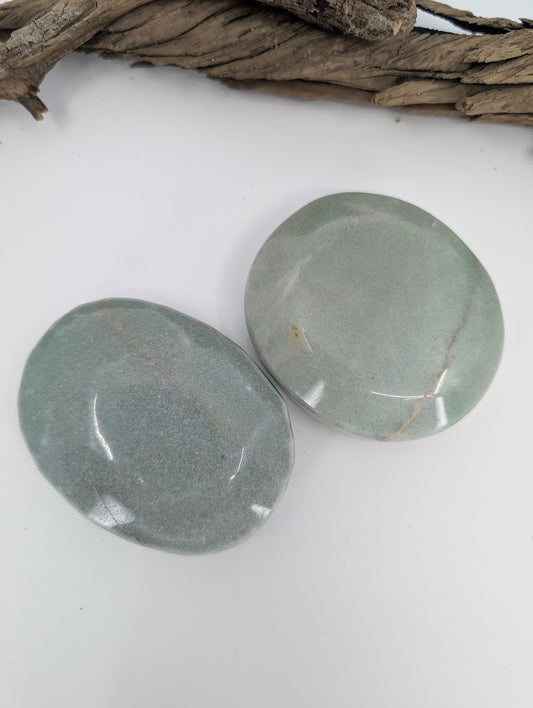 Group of large green aventurine palm stones showing natural color variation