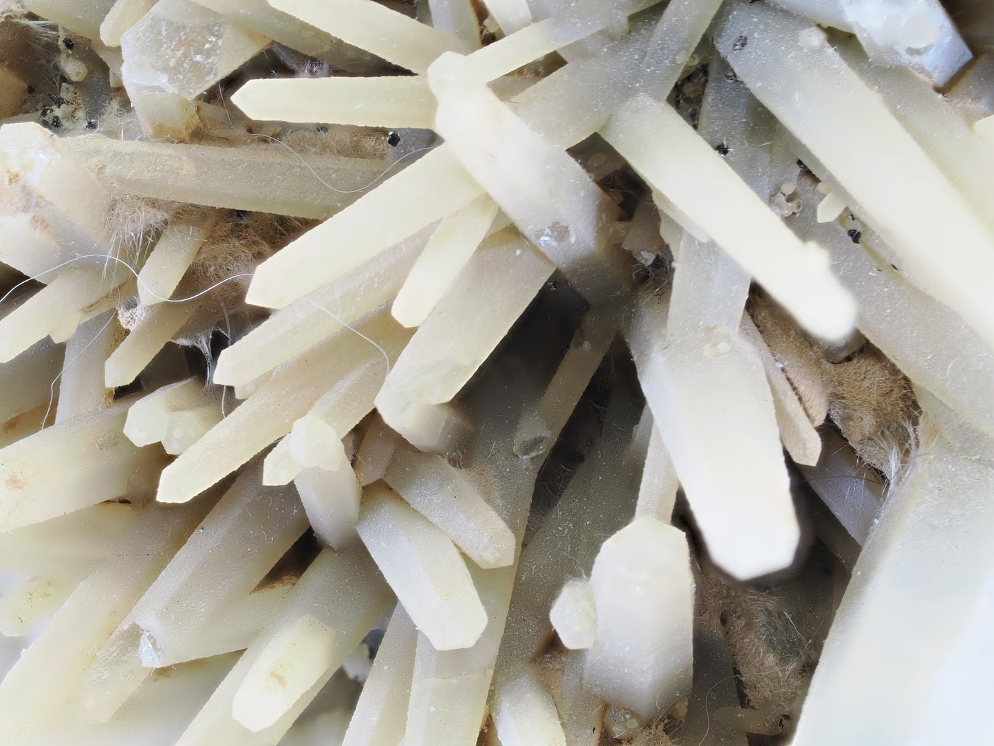 Macro close-up of green quartz crystals showing natural frosted texture and growth interference.