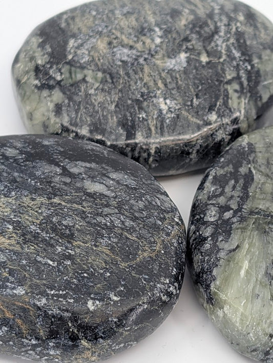 Close-up of polished Green Jade Palm Stone highlighting fibrous texture