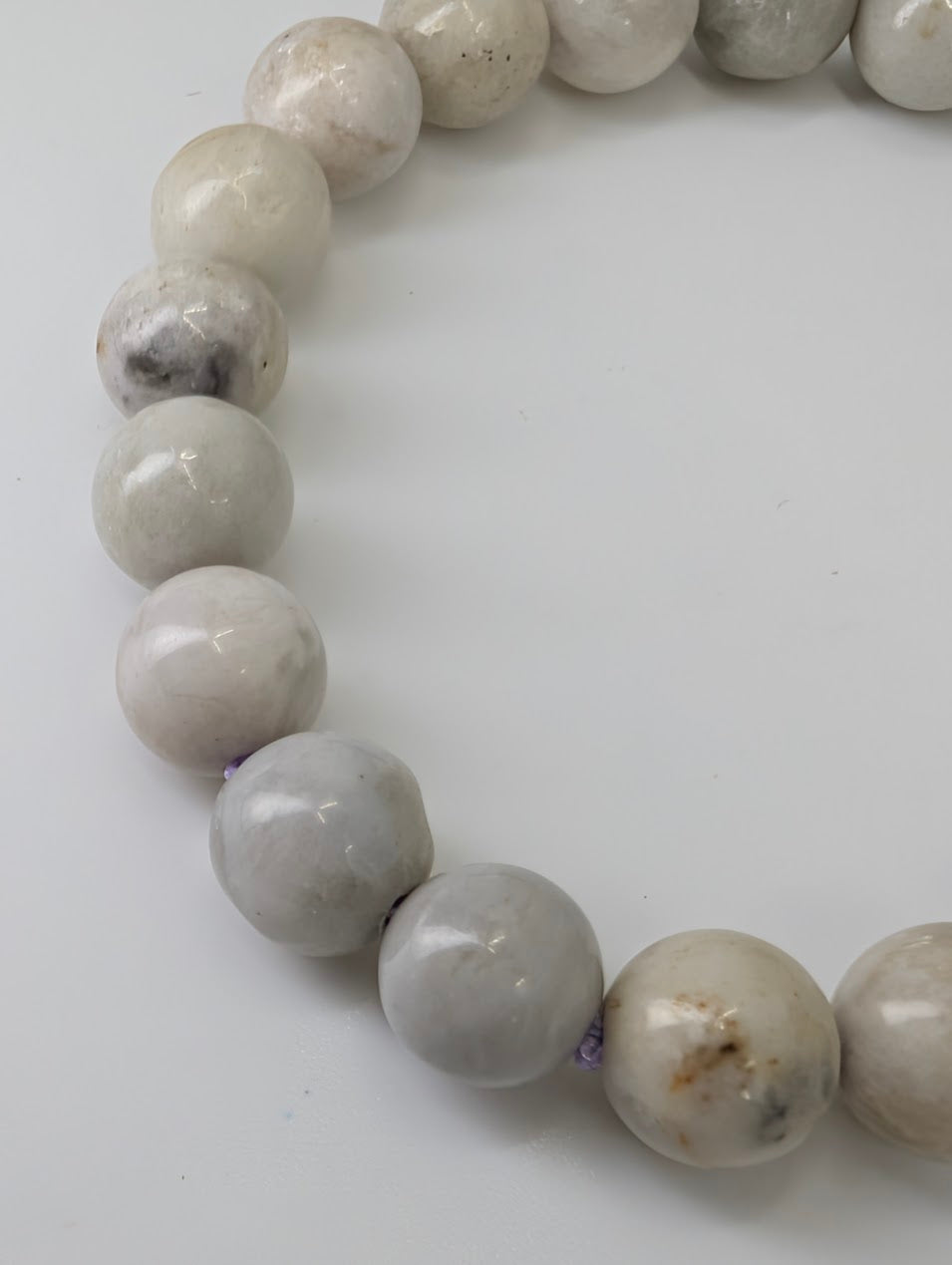 Angled detail shot of hackmanite bracelet highlighting bead texture and polish