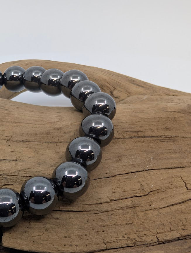 Macro of hematite beads showing high-polish gunmetal lustre
