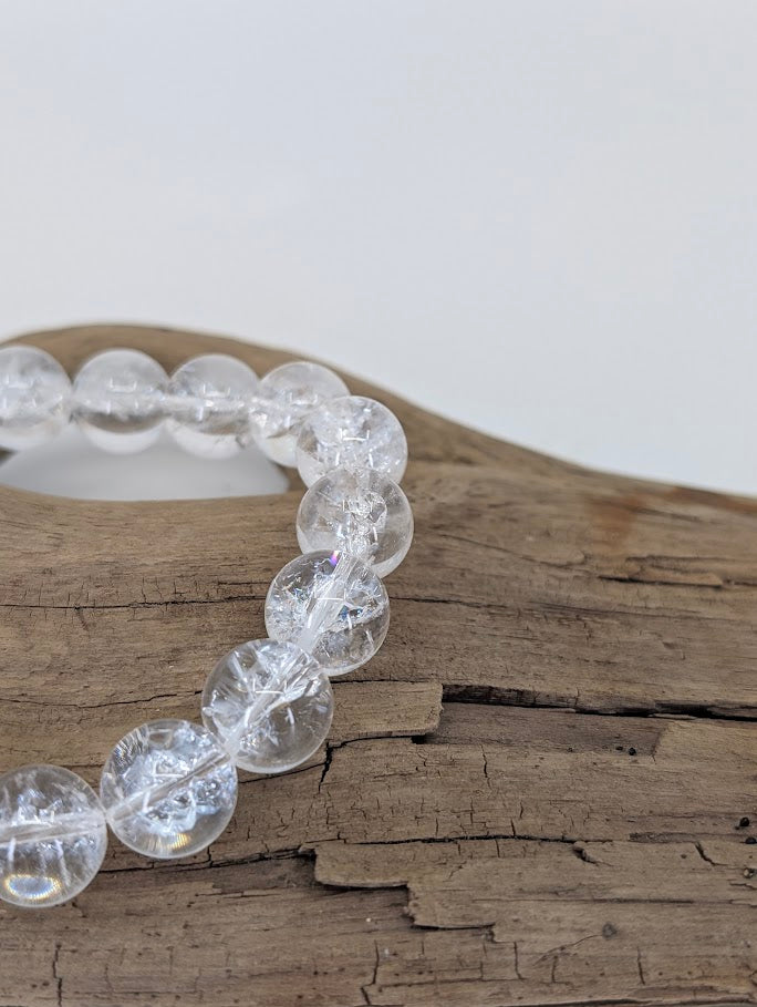 Macro photo showing clear quartz beads with fracture rainbows