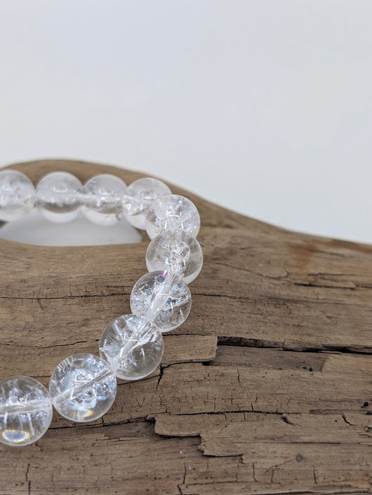 Macro photo showing clear quartz beads with fracture rainbows