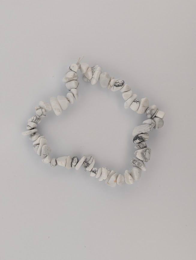 Overhead view of Howlite chip bead stretch bracelet on white background