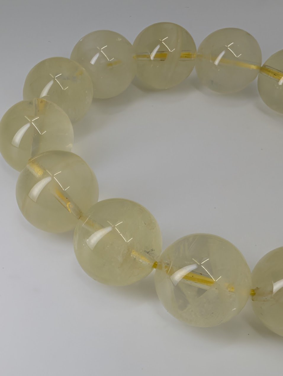 Close-up of 16mm Brazilian citrine bracelet showing clarity and champagne-yellow quartz beads