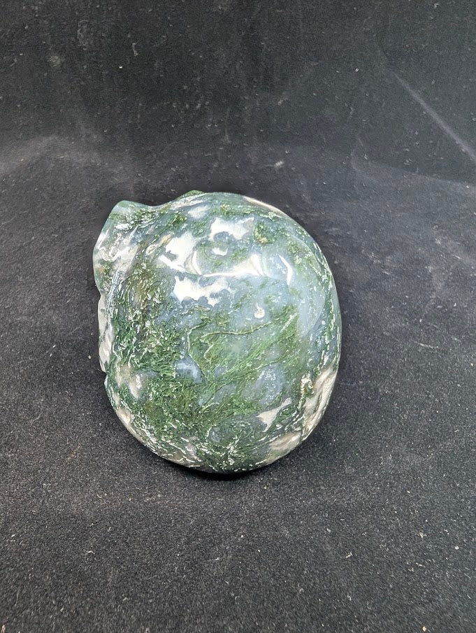 Back side view of Moss Agate Jack Skellington carving showing green dendritic “moss” inclusions and glossy polish
