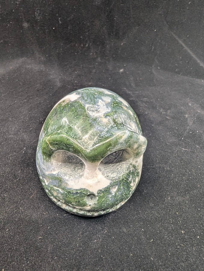 Top view of Moss Agate Jack Skellington carving showing green dendritic “moss” inclusions and glossy polish