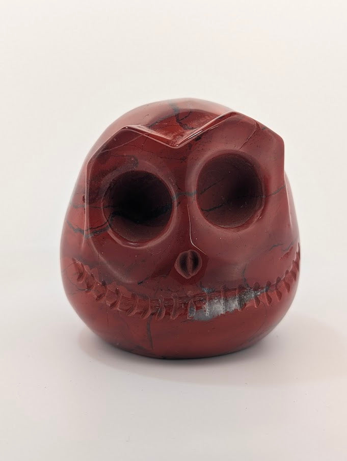 Detail of Red Jasper Jack Skellington carving showing rich red tones and natural veining