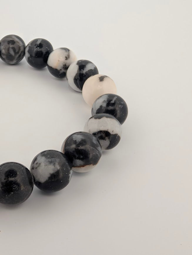 Angled close-up highlighting natural contrast and pattern in Zebra Jasper beads