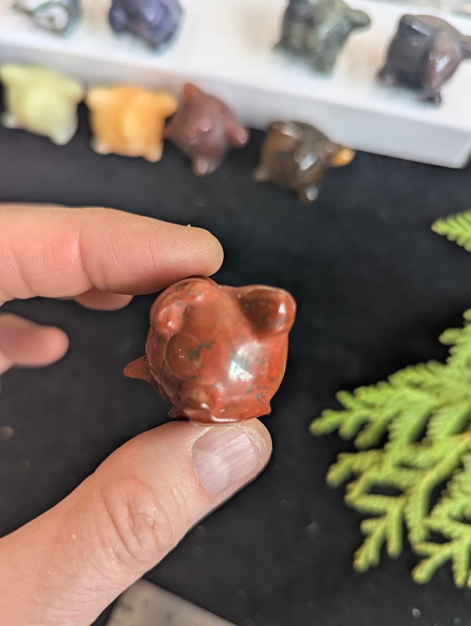Side profile of a 3cm Red Jasper Jigglypuff showing the round, balloon-like shape.