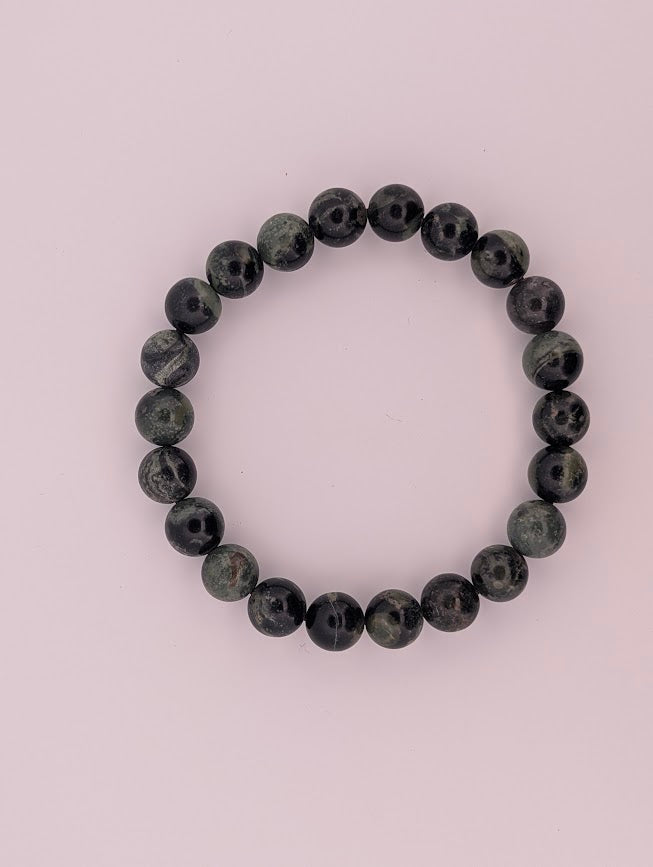 Overhead view of 8mm Kambaba Jasper bracelet on light background