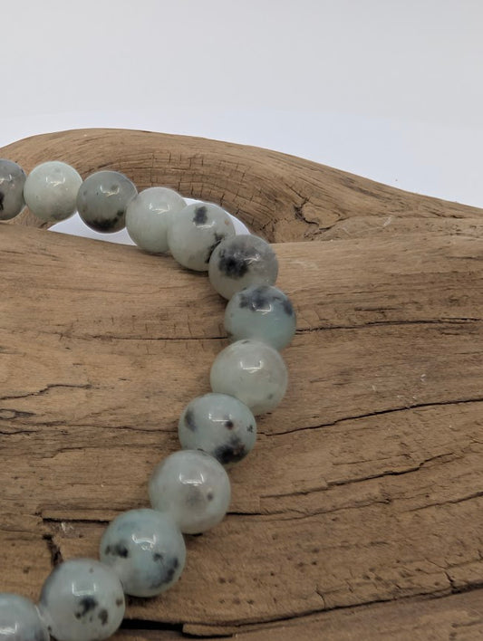 Close-up of Kiwi Jasper beads highlighting polished finish and natural speckling