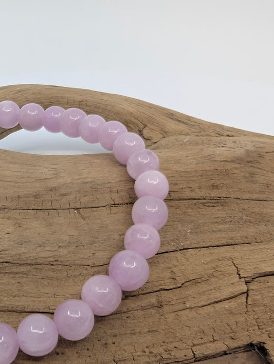 Macro of 6mm Kunzite beads with high polish and gentle pastel color