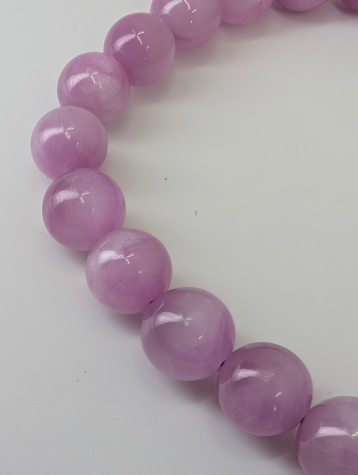 Close up of 8 mm Kunzite bracelet with pastel color and smooth finish