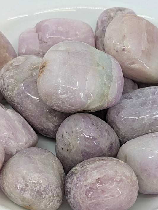 Close-up of Kunzite tumbled stones showing lilac and pink zoning