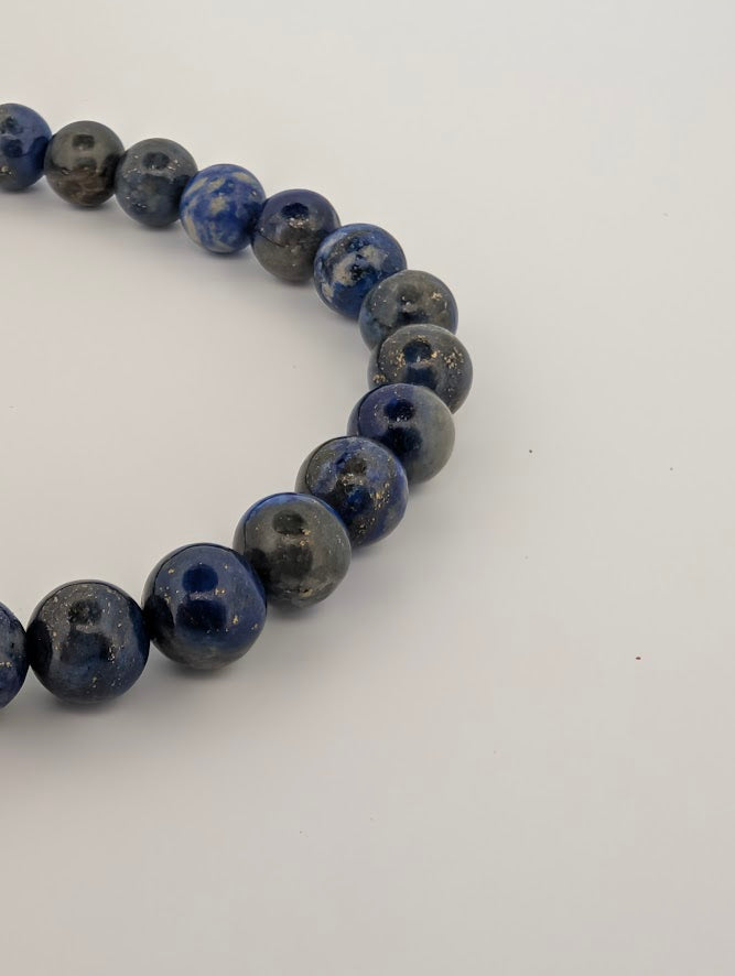 Closeup of 8mm Lapis Lazuli beads with sparkling pyrite inclusions.