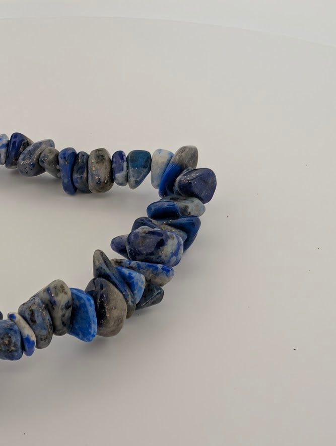 Detail of tumbled chip bracelet highlighting natural blue tones and calcite veining.