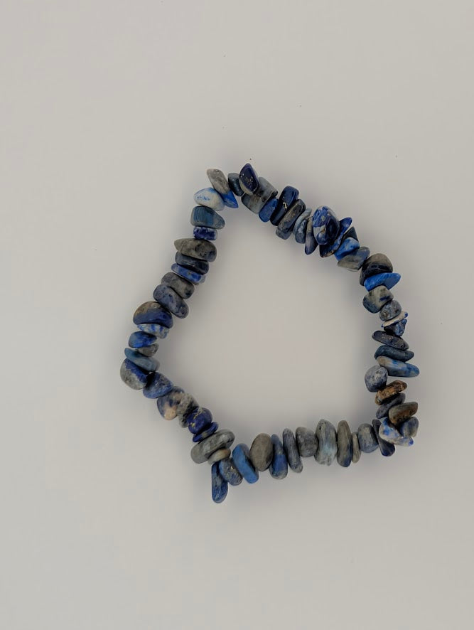 Top-down view of Lapis Lazuli chip bracelet on white background.