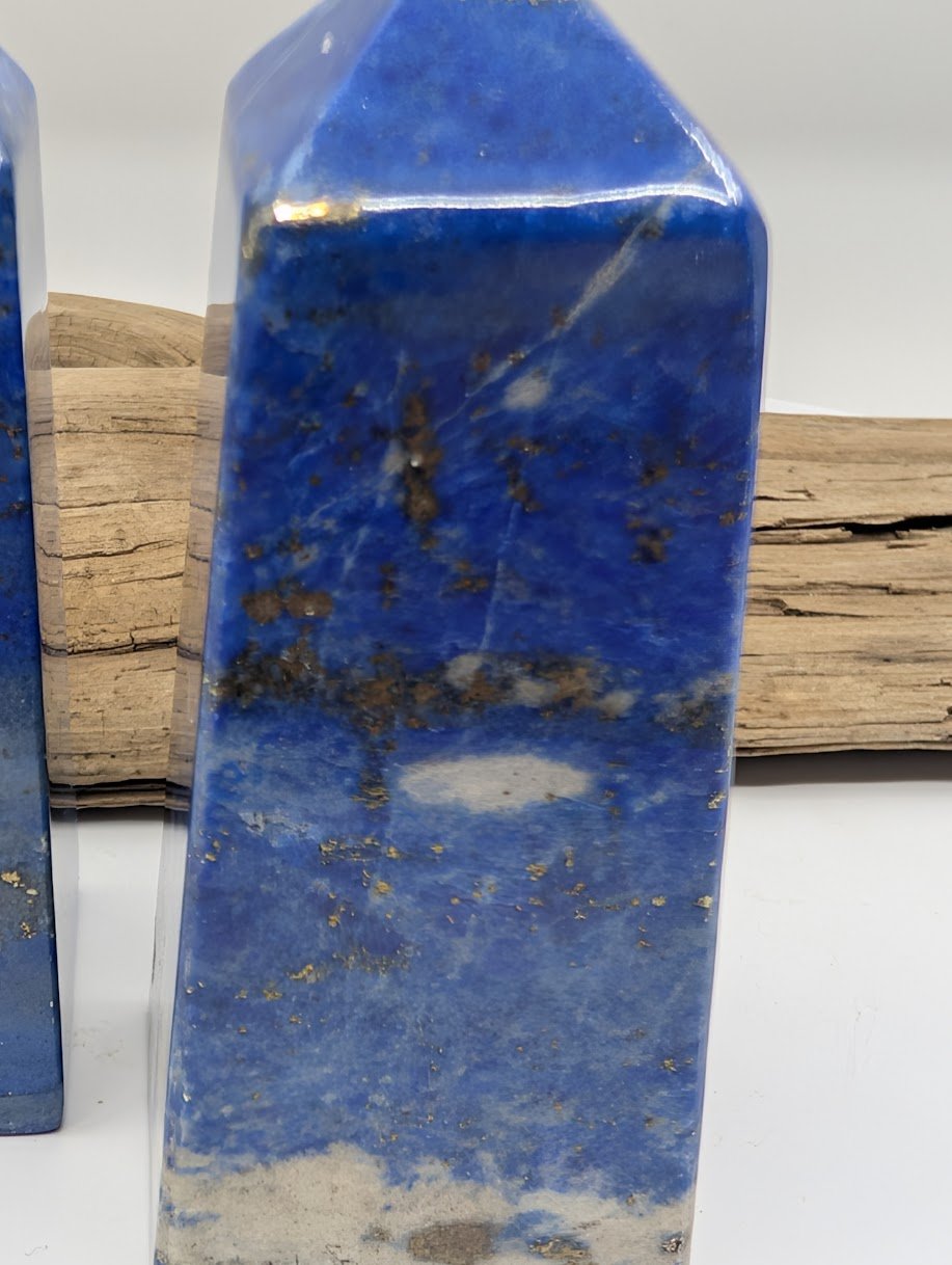 Close up detail of Lapis Lazuli point showing polished facets and natural pyrite inclusions.