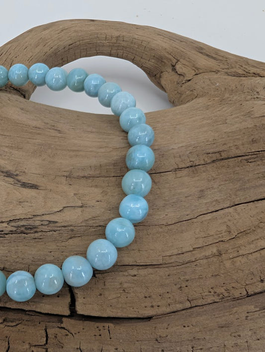 Close-up of Larimar beads showing gentle white marbling