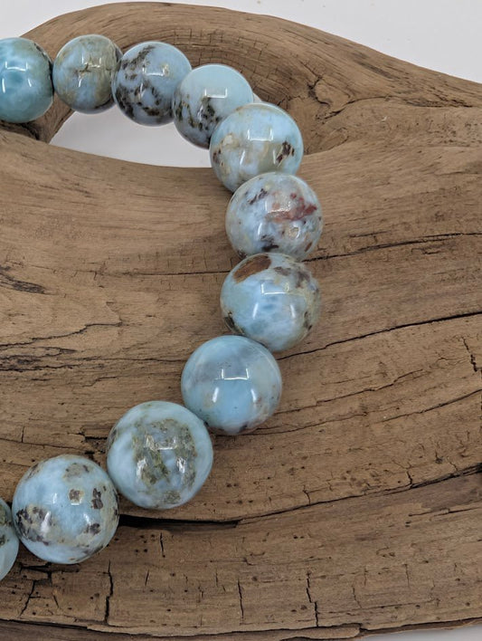 Close-up of Larimar beads showing matrix and polish