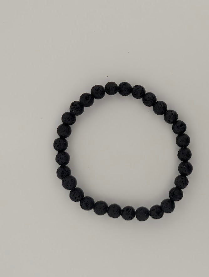 6mm lava stone bracelet laid flat in a circle on white background