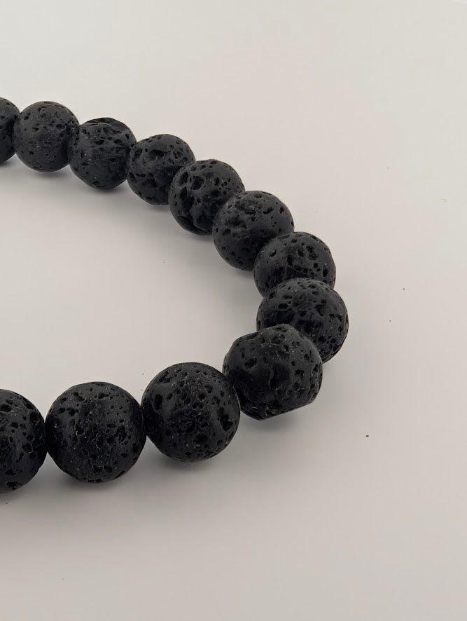 Angled view of 8mm lava stone bracelet highlighting bead texture