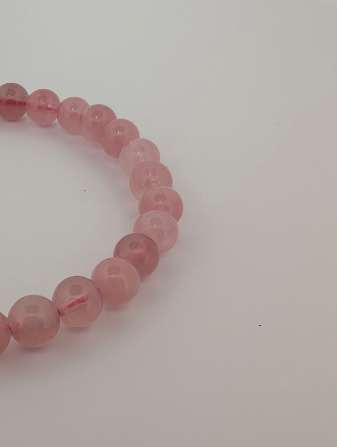 Close-up of 6mm lavender rose quartz beads showing soft pastel color