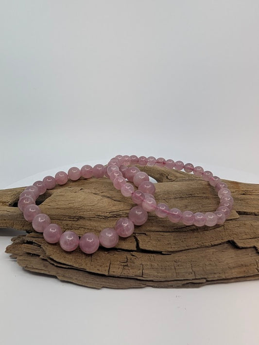 Lavender rose quartz bracelet with 8mm and 6MM polished beads on driftwood