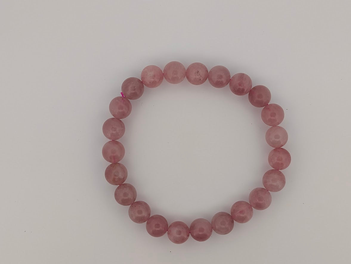 Flatlay of 8mm lavender rose quartz bracelet on neutral background