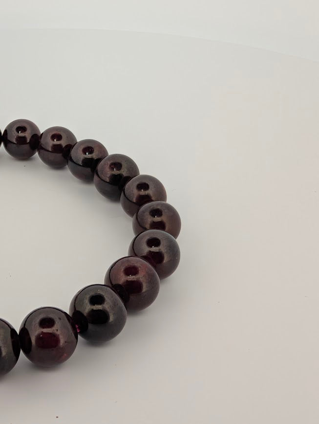 Close-up of 8mm round garnet beads with high polish and shine