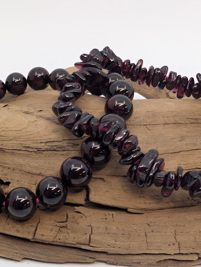 Close-up of deep red garnet beads showing polish and color
