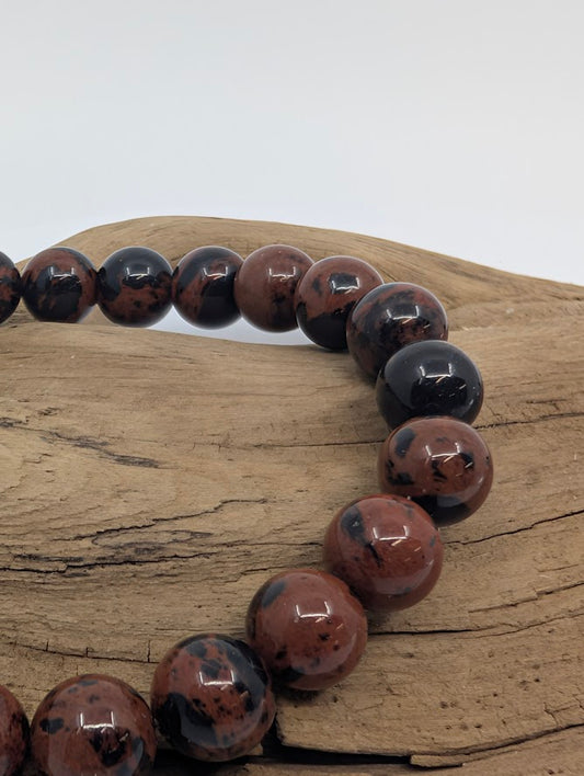 Close-up of mahogany obsidian beads showing natural black mottling