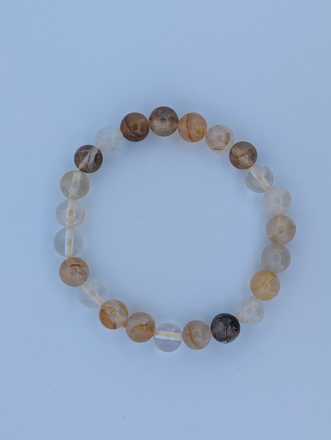 Overhead view of Golden Healer Quartz 8mm bracelet on white background