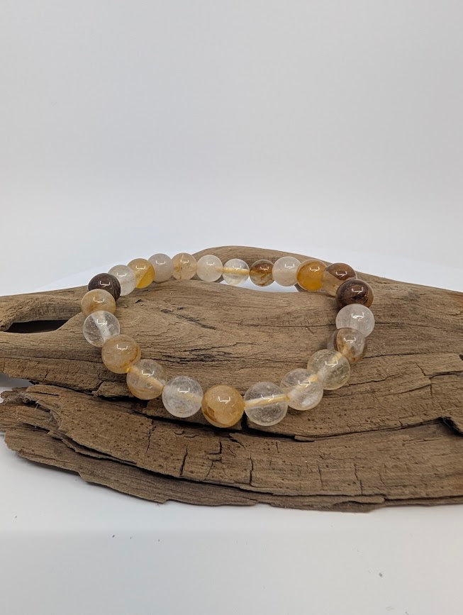 Golden Healer Quartz 8mm round bead stretch bracelet on driftwood, warm honey tones