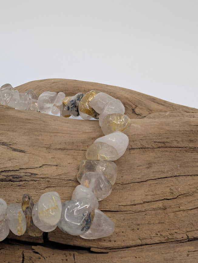 Close-up of Golden Rutile Quartz chips with vivid gold rutile threads