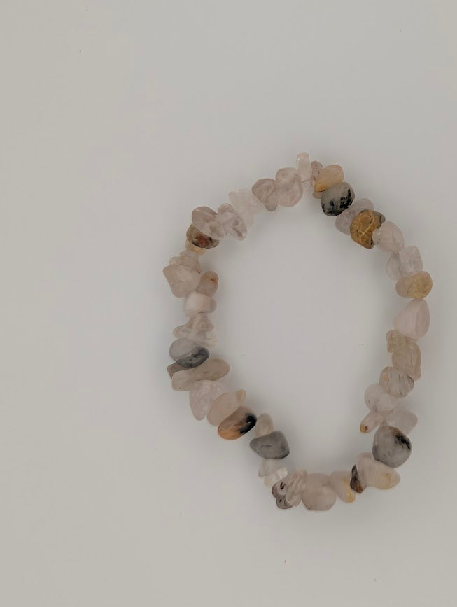 Overhead view of Golden Rutile Quartz chip bracelet on white background