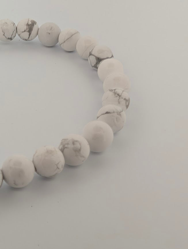 Macro of 6mm Howlite round beads showing clean white tone and subtle grey lines
