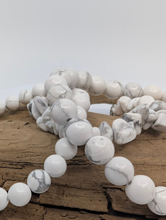 Macro of mixed Howlite bracelets showing undyed white stone and natural grey webbing