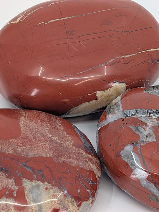 Close-up of Large Red Jasper Palm Stone polished surface and color texture