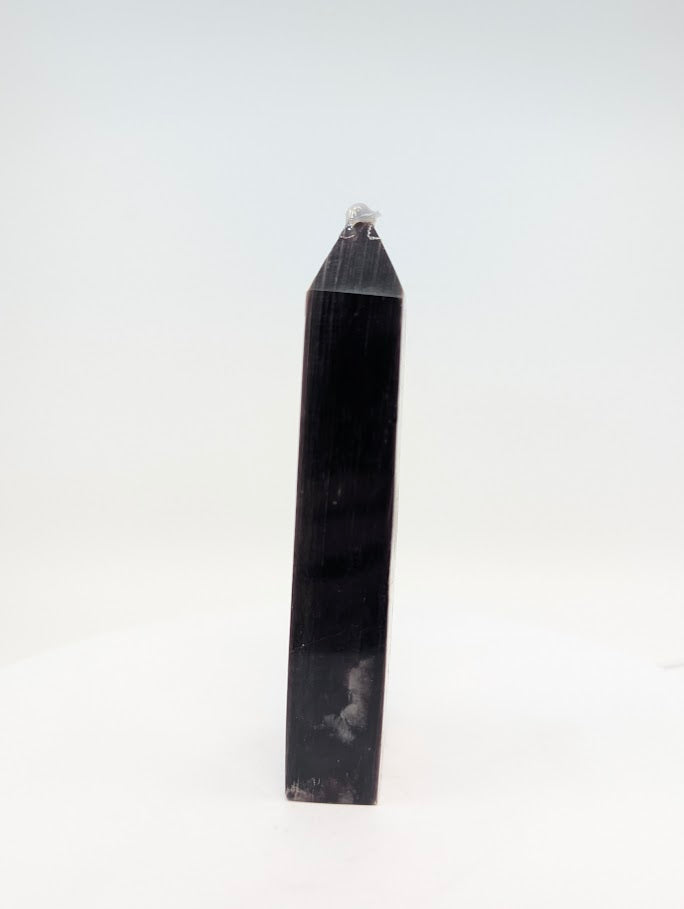 Side view of purple mica Lepidolite tower from Minas Gerais Brazil showing mica layer reflection