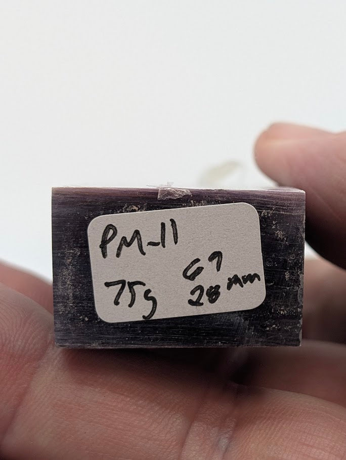 Base label of Lepidolite tower PM-11 showing 75 g weight and 6.9 cm × 2.8 cm dimensions